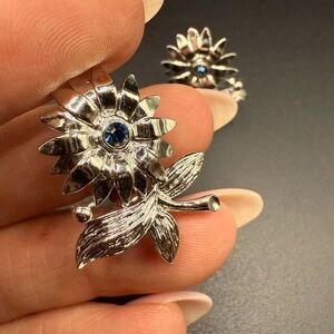 Silver Tone Floral Clip On Earrings with Blue Rhinestone Accent